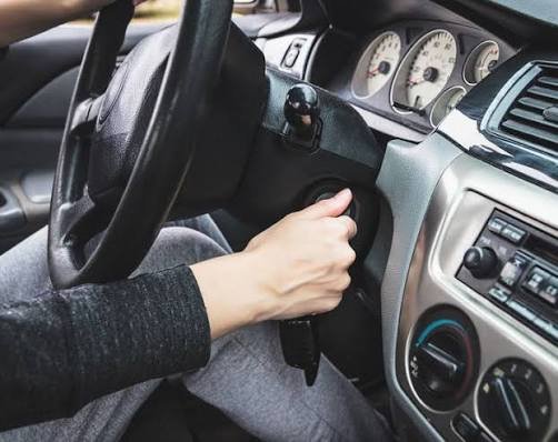 Mechanic troubleshooting a car starting problem