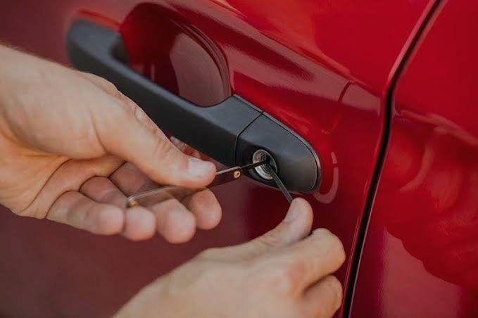 Locksmith unlocking a car door